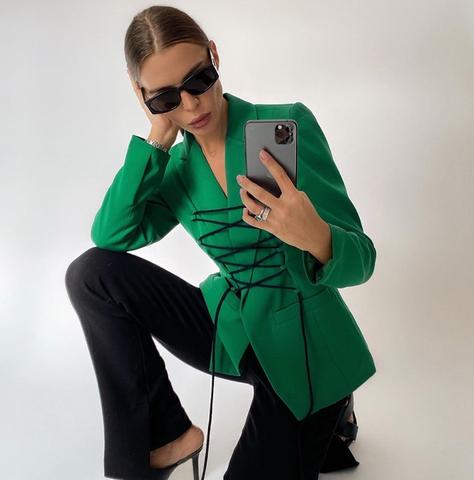 Blazer feminino estruturado com comprimento alongado e detalhe de amarração frontal ajustável, modelagem acinturada moderna