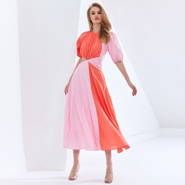 Vestido midi em chiffon com manga curta bufante, recorte na cintura e design em bloco de cor. Look leve, elegante e sofisticado.