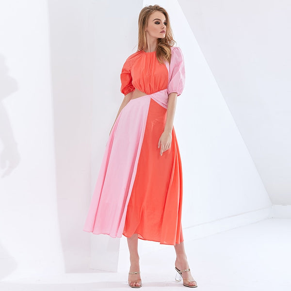 Vestido midi em chiffon com manga curta bufante, recorte na cintura e design em bloco de cor. Look leve, elegante e sofisticado.